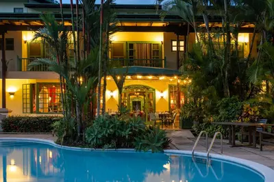 a hotel with a swimming pool in front of a building at Hotel Casa Turire in Turrialba