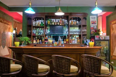 a bar with chairs around it in a pub at Hotel Casa Turire in Turrialba
