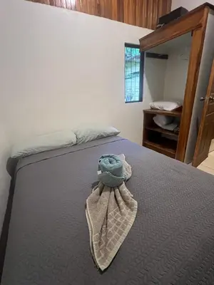 a bedroom with a bed with a stuffed animal on it at Peaceful Jungle Home, River Access, Arenal Views in El Castillo de La Fortuna