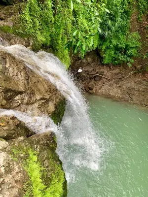 a waterfall on the side of a river at Lapa Roja, 2BR Ocean View Apartment in Villa Mar y Sol, Nature in Manuel Antonio