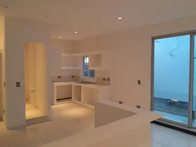 a kitchen with white walls and a large window at Costa Rica Walk in in San José