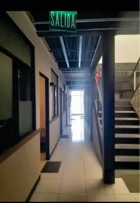 a hallway of a building with a sign that reads salida at Costa Rica Walk in in San José