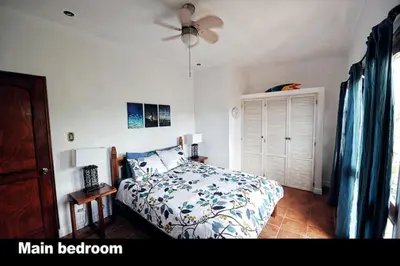a bedroom with a bed and a ceiling fan at 2BR Townhome in Tamarindo• Pool • Walk to Beach in Tamarindo