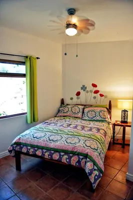 a bedroom with a bed and a window at 2BR Townhome in Tamarindo• Pool • Walk to Beach in Tamarindo