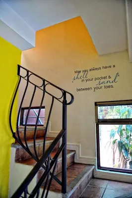 a spiral staircase with a sign on the wall at 2BR Townhome in Tamarindo• Pool • Walk to Beach in Tamarindo