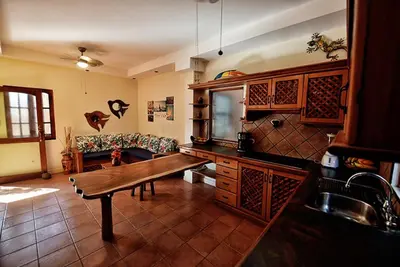a living room with a wooden table and a couch at 2BR Townhome in Tamarindo• Pool • Walk to Beach in Tamarindo
