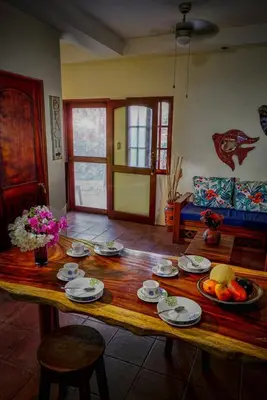 a living room with a wooden table with food on it at 2BR Townhome in Tamarindo• Pool • Walk to Beach in Tamarindo