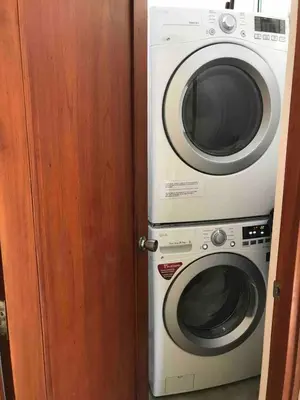 a washer and dryer sitting next to a door at Beachside 1st Floor Condo Near Flamingo & Conchal in Santa Cruz