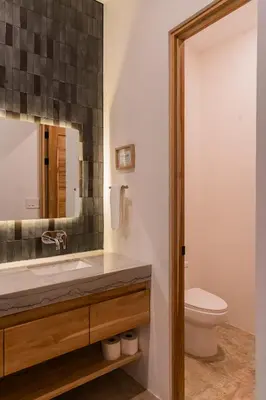 a bathroom with a sink and a toilet at NEW Modern 6BR, Pool, Walk 2 Beach, Sleeps 20 in Playa Guiones