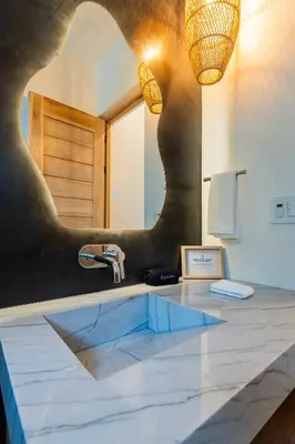 a bathroom with a sink and a mirror at NEW Modern 6BR, Pool, Walk 2 Beach, Sleeps 20 in Playa Guiones