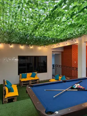a pool table in a living room with a ceiling at Harmony Hotel by Haven in San José