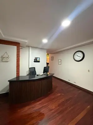 an office with a desk and a clock on the wall at Harmony Hotel by Haven in San José