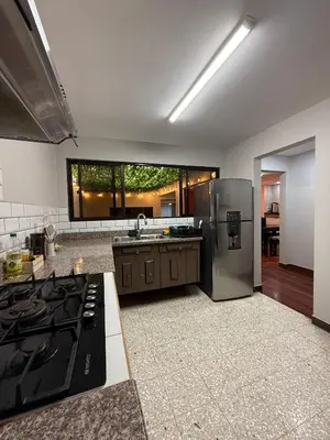a kitchen with a stove and a refrigerator at Harmony Hotel by Haven in San José