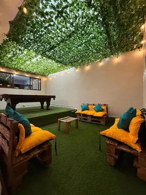 a living room with two beds and a piano at Harmony Hotel by Haven in San José