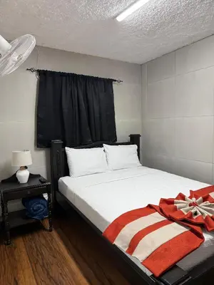 a bedroom with a bed with a red blanket on it at Harmony Hotel by Haven in San José