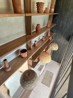 a display of pots and vases on shelves at Las chozas I in Tamarindo