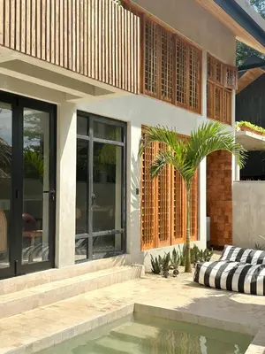 a house with a pool in front of it at Las chozas I in Tamarindo