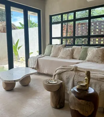 a living room with a couch and a table at Las chozas I in Tamarindo