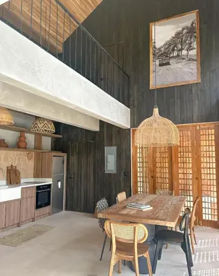 a dining room with a wooden table and chairs at Las chozas I in Tamarindo
