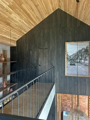 a staircase in a house with a wooden ceiling at Las chozas I in Tamarindo