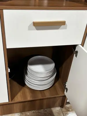 a stack of plates in a cabinet with a stack of dishes at Sonrisas del Arenal, cerca de La Fortuna de SC in Chachagua