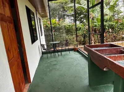 a patio with a sink and a table and chairs at Sonrisas del Arenal, cerca de La Fortuna de SC in Chachagua
