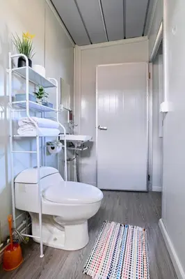 a bathroom with a toilet and a sink at Módulos Yunni in Uvita