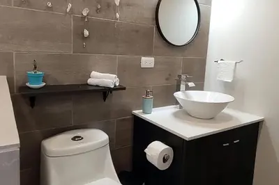 a bathroom with a sink and a toilet and a mirror at Casa Cosmo Samara in Sámara