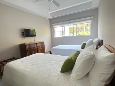 a bedroom with two white beds and a window at Uvita Paradise , Walk to the Ballena Beach in Uvita