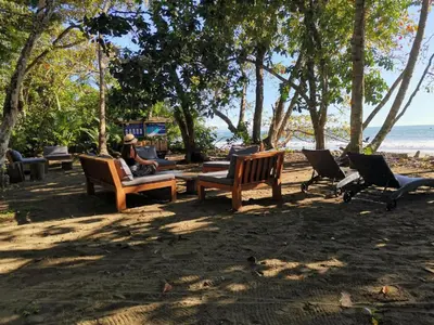 a group of park benches sitting on the beach at Uvita Paradise , Walk to the Ballena Beach in Uvita