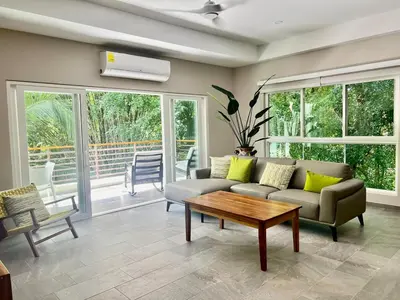 a living room with a couch and a table at Uvita Paradise , Walk to the Ballena Beach in Uvita