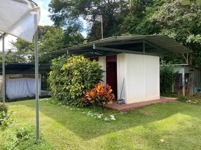a small white house with a canopy in a yard at Rainforest Glamping, Forest Bathing in the Osa Region in Ciudad Cortés