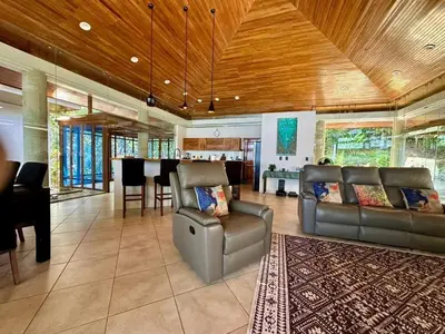 a living room with a couch and a table at Luxurious Rainforest Retreat in Drake Bay, Osa, Costa Rica in Drake