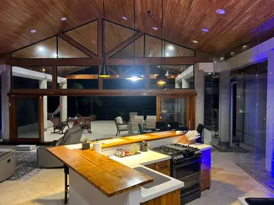 a kitchen and living room with a stove at Luxurious Rainforest Retreat in Drake Bay, Osa, Costa Rica in Drake
