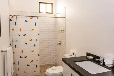 a bathroom with a shower with a wall with fish on it at Villa Lapas and Apartment, Central, Pool and lots of Wildlife in Manuel Antonio