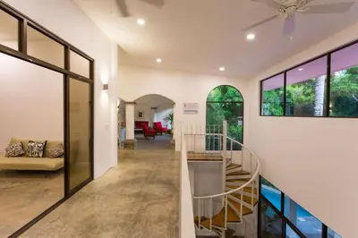 a hallway with a spiral staircase in a house at Villa Lapas and Apartment, Central, Pool and lots of Wildlife in Manuel Antonio