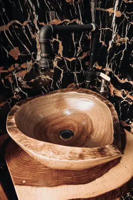 a wooden sink in a bathroom with a stone wall at El Carpintero Guest House in Fortuna