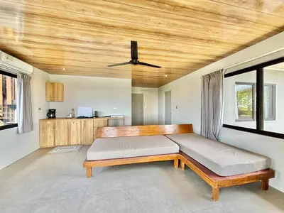 a bedroom with a bed and a wooden ceiling at NulaKai Boutique Apartments in Santa Teresa Beach