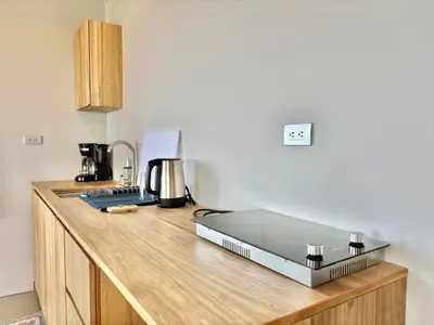 a kitchen counter with a laptop on top of it at NulaKai Boutique Apartments in Santa Teresa Beach