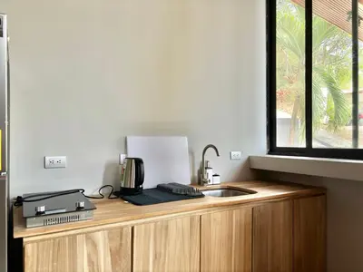 a kitchen counter with a sink and a window at NulaKai Boutique Apartments in Santa Teresa Beach