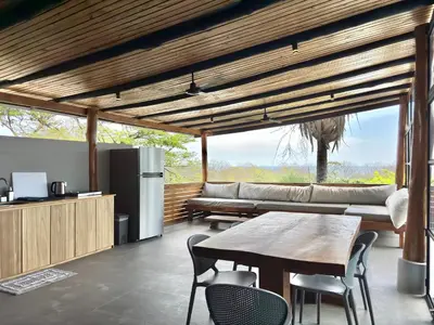 a living room with a table and a couch at NulaKai Boutique Apartments in Santa Teresa Beach
