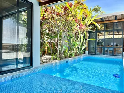 a swimming pool in the middle of a house at NulaKai Boutique Apartments in Santa Teresa Beach