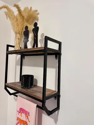 a black shelf with two figurines on it at Original Studio ESCALANTE in San José