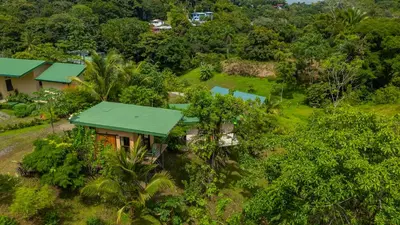 an aerial view of a house with a green roof at Kalegio Lodge Full Furnished Apartments in Manuel Antonio