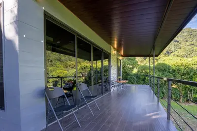 a balcony of a house with chairs on it at Villa Centinela in Monteverde Costa Rica