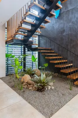 a staircase in a house with plants and rocks at Modern 4BR with Pool, Walk2Beach, Yoga Deck, Sleeps 14 in Nosara