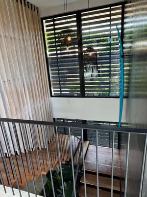 a balcony with a window with blinds at Modern 4BR with Pool, Walk2Beach, Yoga Deck, Sleeps 14 in Nosara