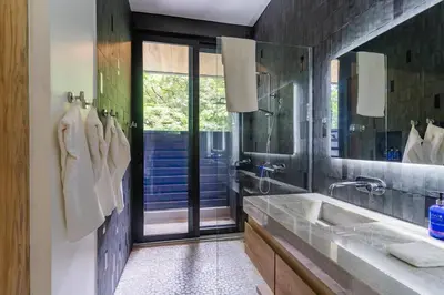 a bathroom with a sink and a large mirror at Modern 4BR with Pool, Walk2Beach, Yoga Deck, Sleeps 14 in Nosara