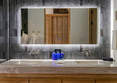 a bathroom sink with a large mirror above it at Modern 4BR with Pool, Walk2Beach, Yoga Deck, Sleeps 14 in Nosara