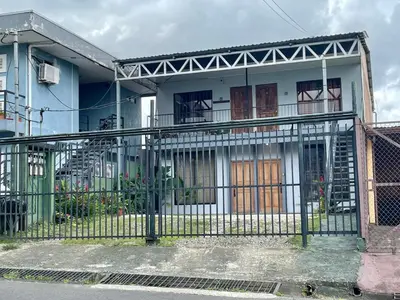 a blue and white house with a gate at Rous place# 2 in Fortuna